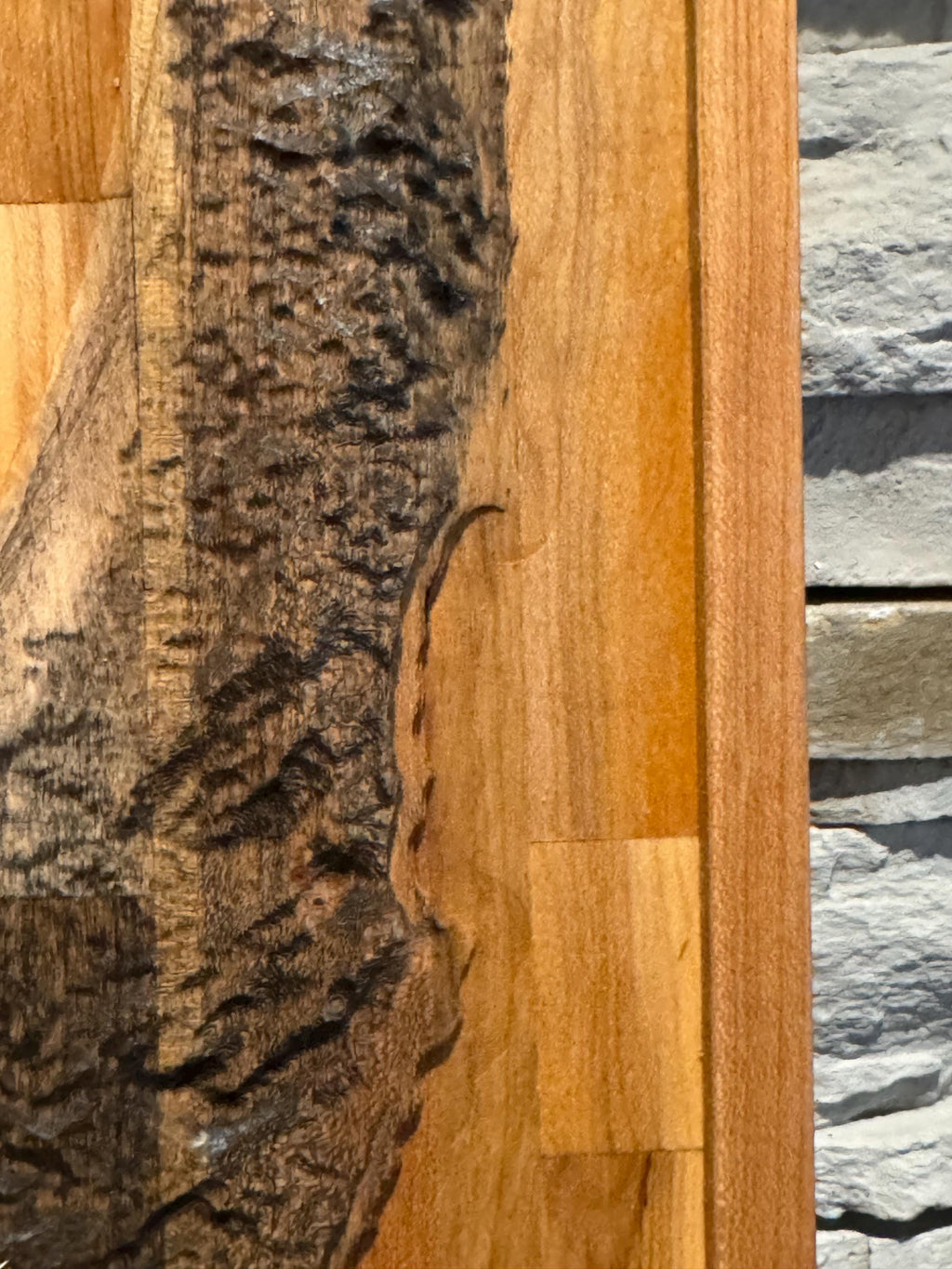 A high-angle close-up looking down at the carved wooden map, emphasizing the contrast between the rough, natural live-edge bark and the smooth, polished wood surfaces __etsy:8156428506