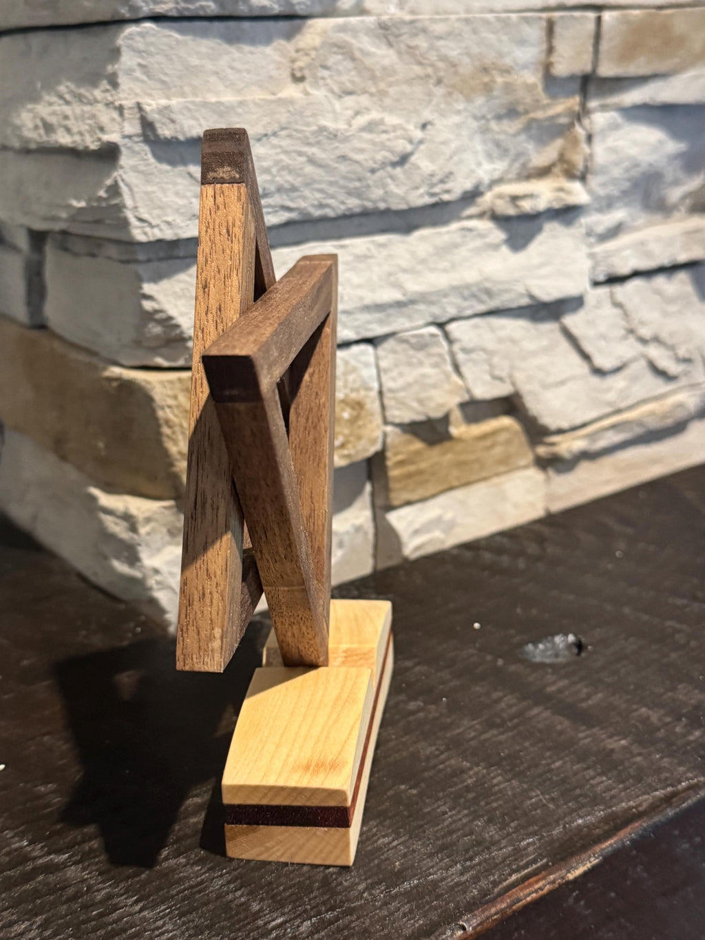 A high-angle side view of the handcrafted wooden Star of David art piece. The perspective emphasizes the thick, sturdy build of the interlocking star shapes and the contrasting layers of the multi-toned wooden base. __etsy:8204393859