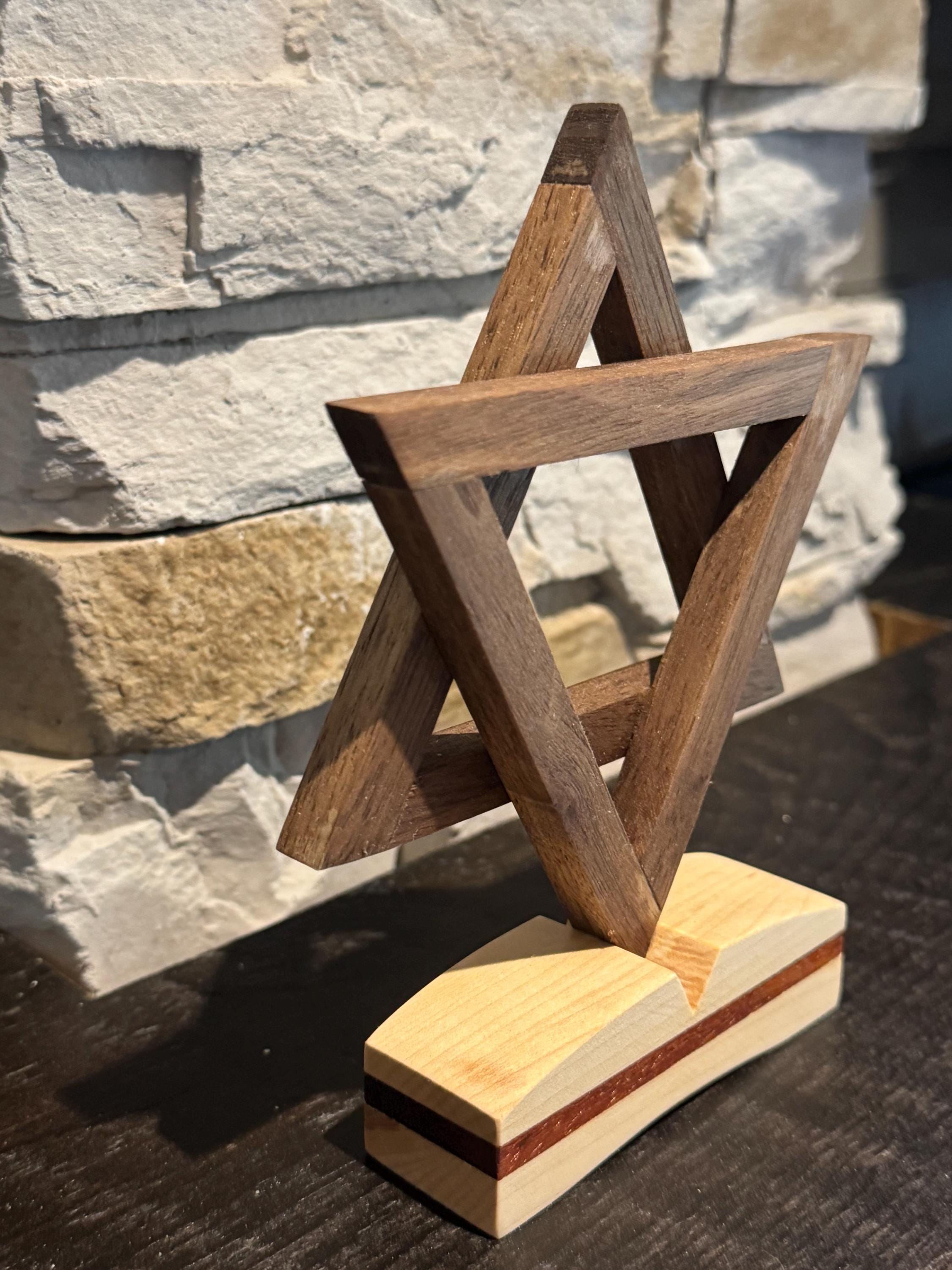A straight-on side profile view of the wooden Star of David sculpture, highlighting the precise alignment of the interlocking geometric segments and how they securely attach to the flat, rectangular wooden base. __etsy:8156470170