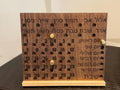 Front view of a handcrafted wooden Hebrew perpetual calendar showing engraved Hebrew months and days, with adjustable bronze pins marking the date. __etsy:8204556623