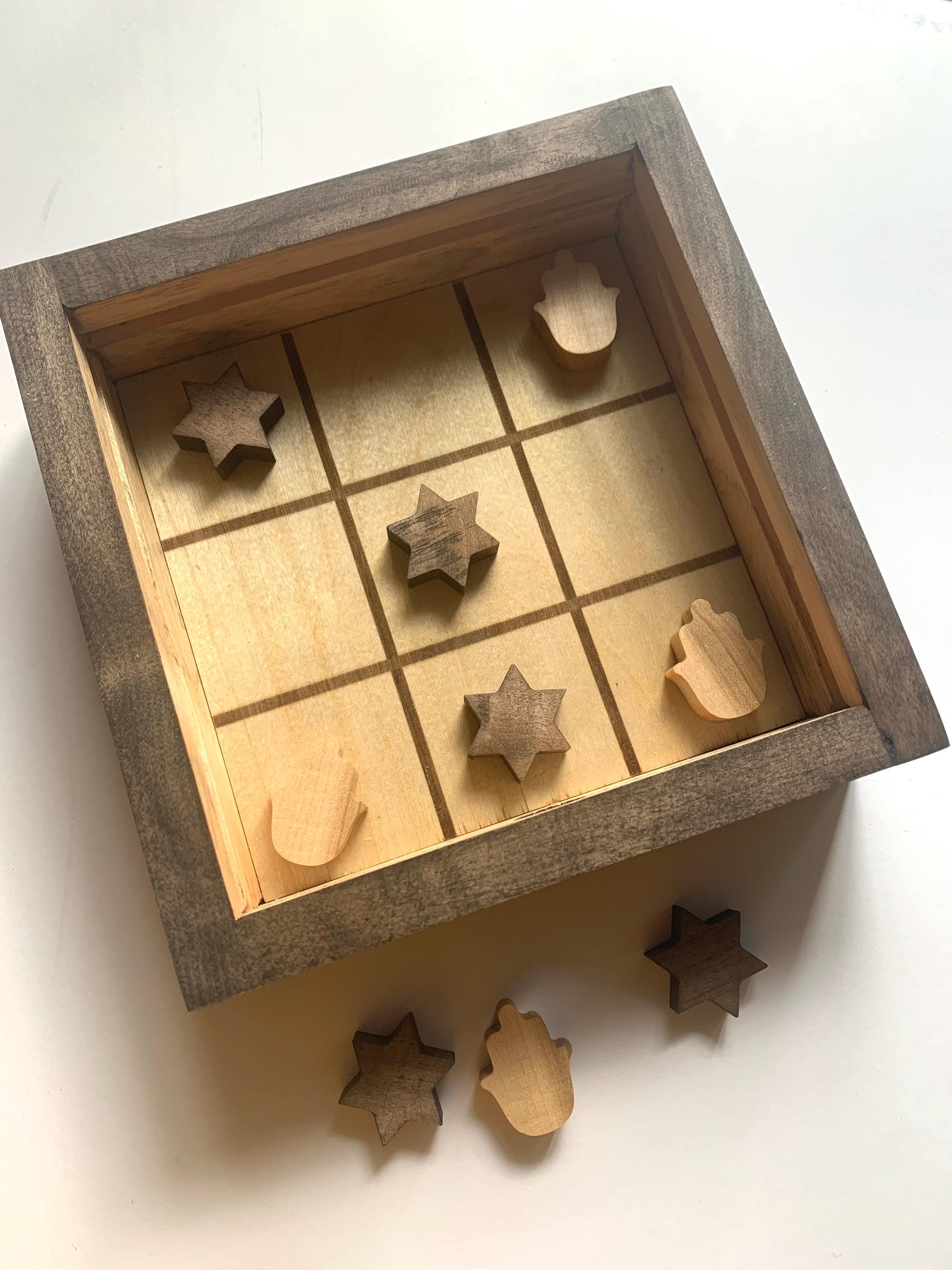 Game of Tic Tac Toe made out of wood, with acrylic cover and two toned pieces in the shape of hamsas and stars of David __etsy:6646450895