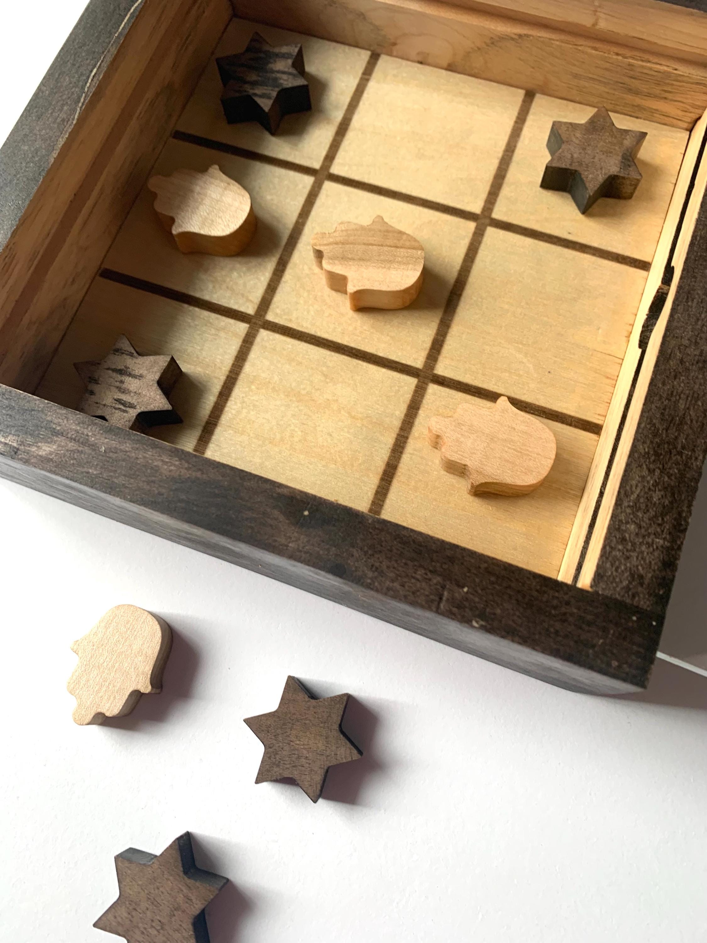 Game of Tic Tac Toe made out of wood, with acrylic cover and two toned pieces in the shape of hamsas and stars of David __etsy:6646451493